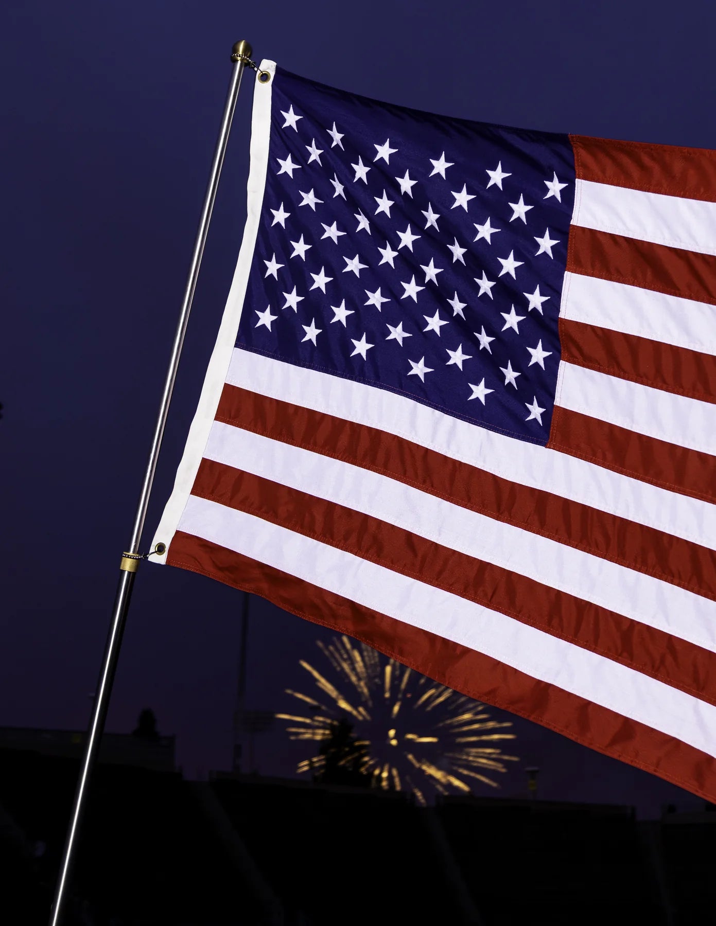 American flag and brass ball topper in close detail